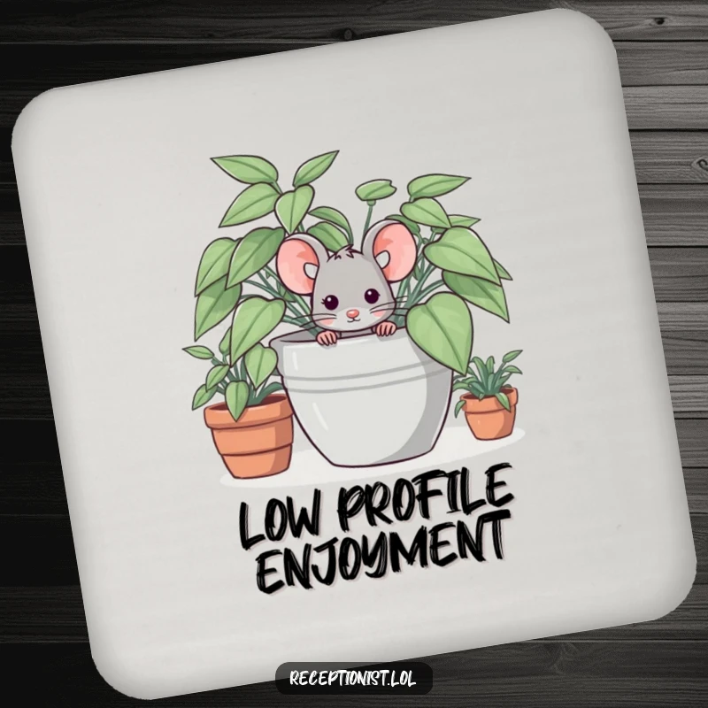 Funny drink coaster with a shy mouse character hiding behind a plant, offering subtle humor and surface protection.