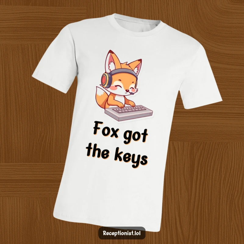 Funny fox t-shirt featuring a cartoon fox with headphones, typing rapidly on a keyboard; a humorous design for tech enthusiasts.